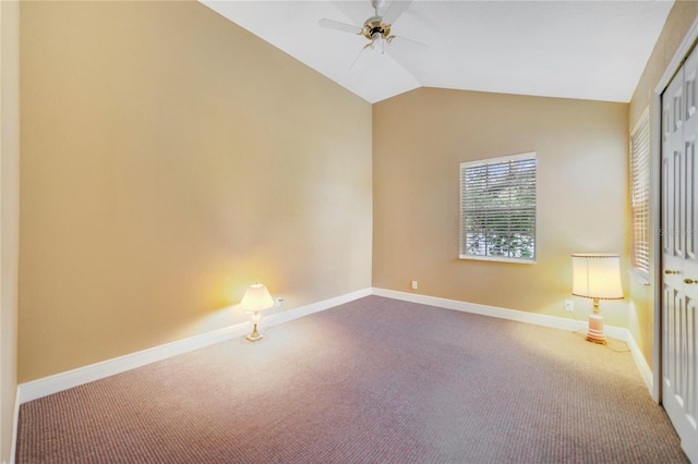 carpeted empty room with baseboards, vaulted ceiling, and a ceiling fan