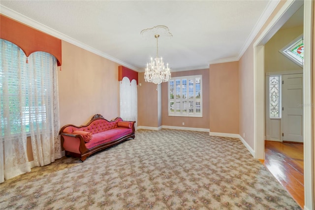 living area with ornamental molding, carpet flooring, baseboards, and an inviting chandelier