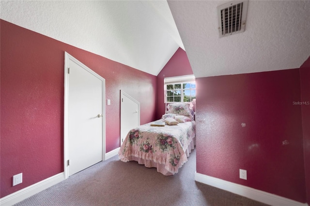 bedroom featuring a textured ceiling, carpet floors, visible vents, baseboards, and vaulted ceiling