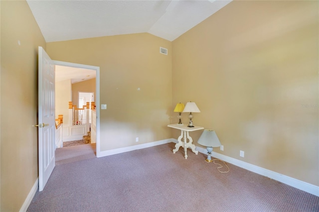 interior space featuring lofted ceiling, visible vents, and baseboards