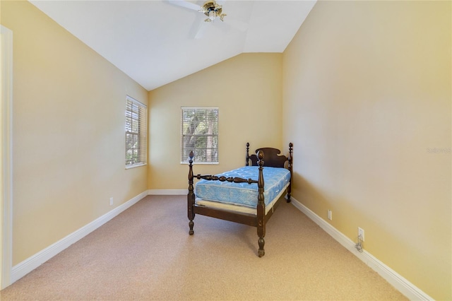 bedroom with ceiling fan, carpet, baseboards, and vaulted ceiling