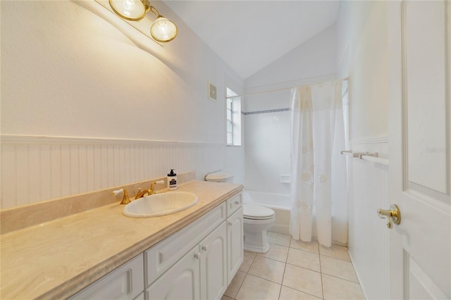 full bathroom featuring lofted ceiling, toilet, a wainscoted wall, tile patterned floors, and shower / bath combination with curtain