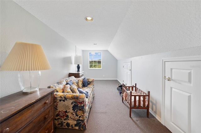 sitting room with a textured ceiling, baseboards, vaulted ceiling, and carpet flooring