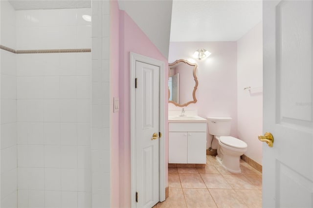 bathroom with toilet, tile patterned flooring, vanity, and baseboards