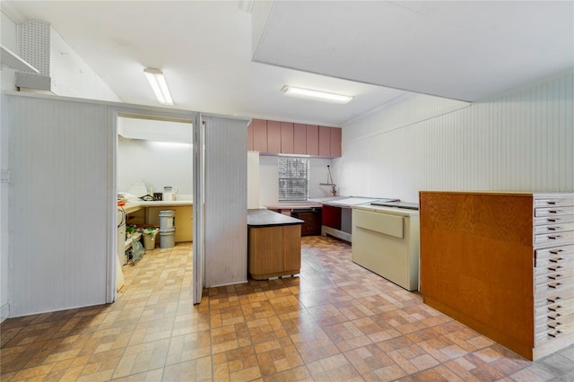 kitchen with light countertops and brick patterned floor