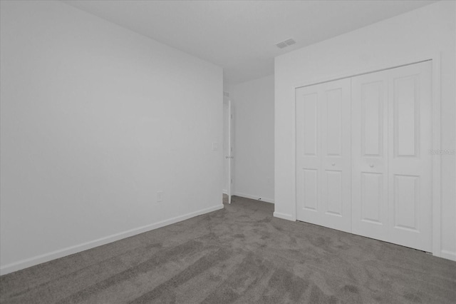 unfurnished bedroom with a closet and carpet