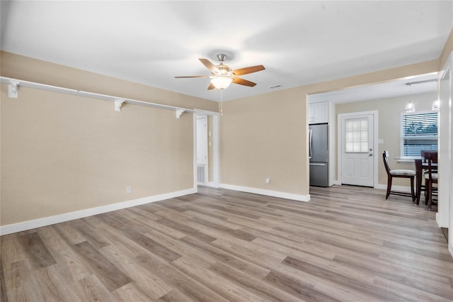 unfurnished living room with ceiling fan and light hardwood / wood-style floors