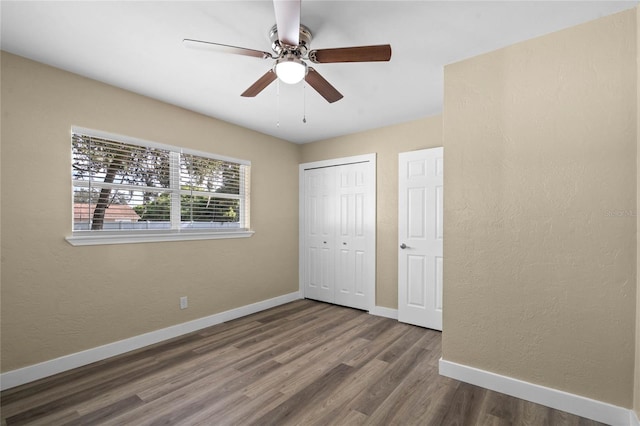 unfurnished bedroom featuring wood-type flooring, a closet, and ceiling fan