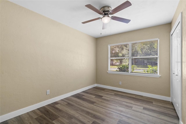 empty room with ceiling fan and wood-type flooring