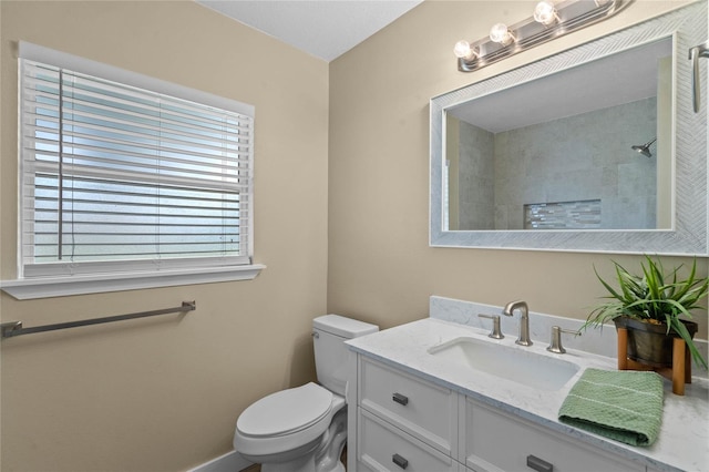 bathroom featuring toilet, walk in shower, and vanity