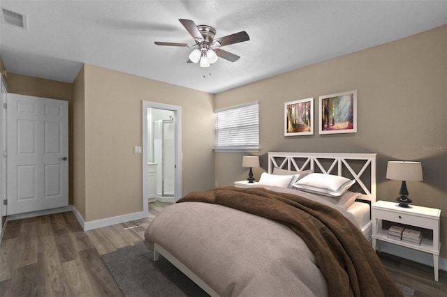 bedroom with wood-type flooring, ensuite bath, and ceiling fan