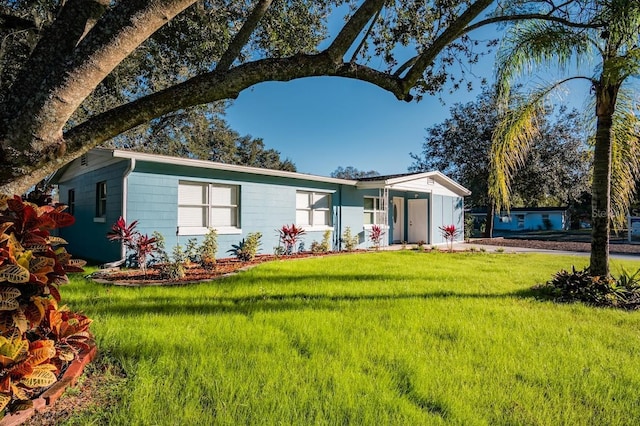 ranch-style house with a front lawn