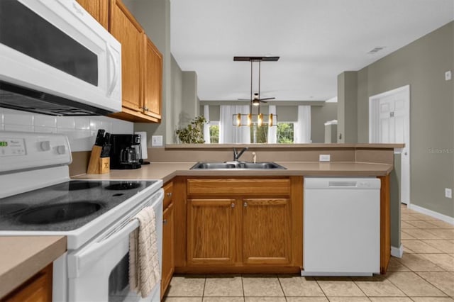 kitchen featuring light tile patterned floors, kitchen peninsula, ceiling fan, and white appliances