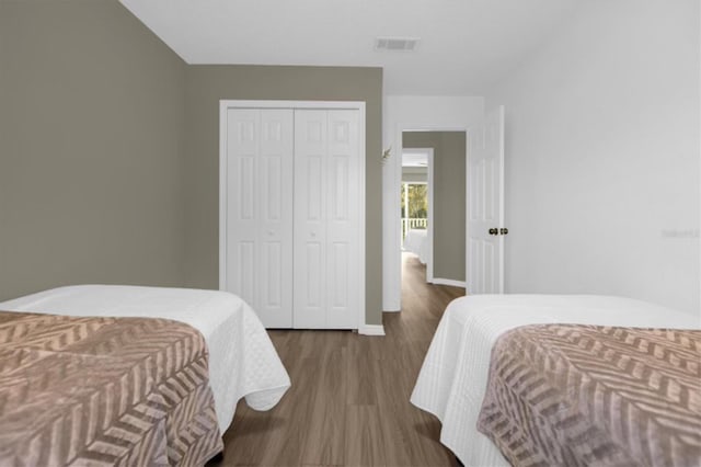 bedroom with a closet and hardwood / wood-style flooring