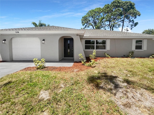 ranch-style home with a garage and a front yard