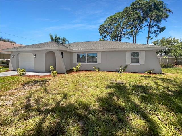 ranch-style home with a front yard, concrete driveway, an attached garage, and stucco siding