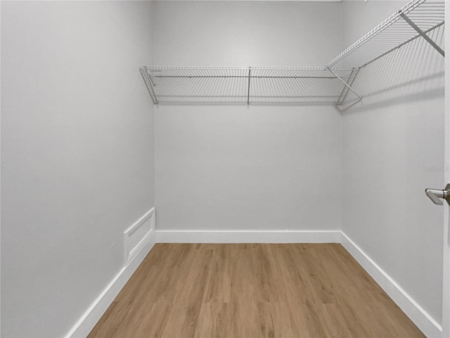 spacious closet featuring visible vents and wood finished floors