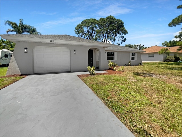 ranch-style home with driveway, a front lawn, an attached garage, and stucco siding