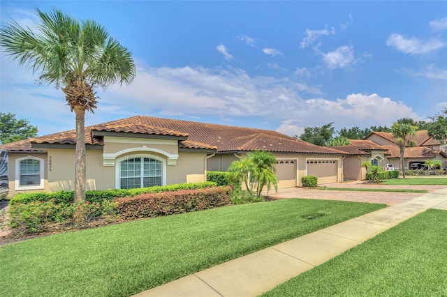 mediterranean / spanish house with stucco siding, a garage, driveway, a tiled roof, and a front lawn