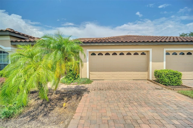 mediterranean / spanish house featuring decorative driveway and stucco siding