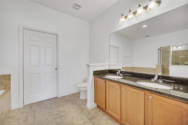 full bath featuring a stall shower, a sink, toilet, and tile patterned floors