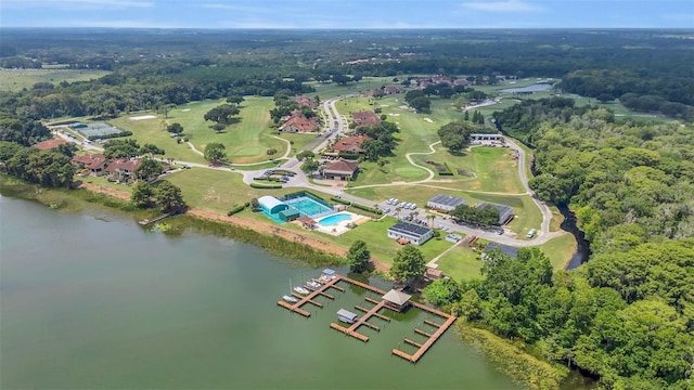 birds eye view of property featuring a water view and a wooded view