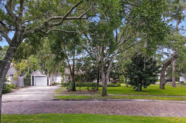 obstructed view of property featuring a garage and a front lawn