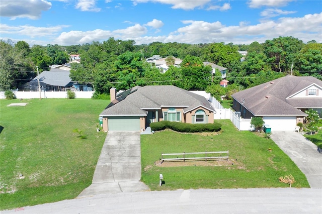 view of front of home with a front lawn and a garage