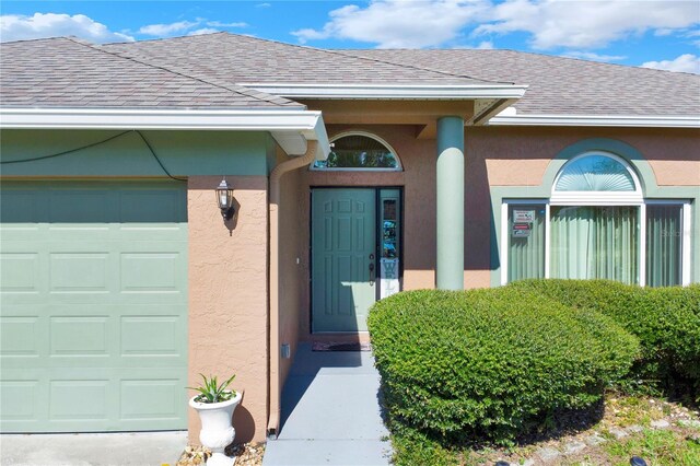 doorway to property with a garage