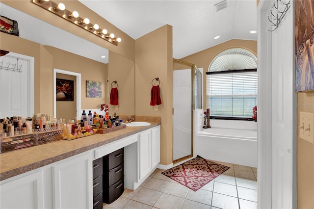 bathroom with separate shower and tub, vanity, lofted ceiling, and tile patterned flooring