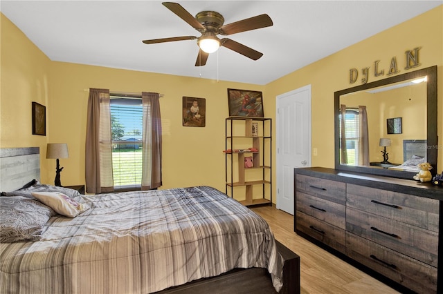 bedroom with ceiling fan and light hardwood / wood-style flooring