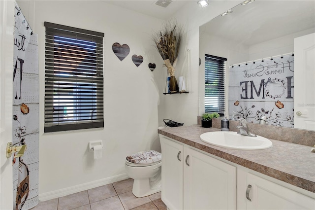 bathroom featuring vanity, toilet, and tile patterned flooring