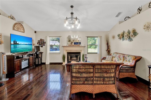 living room with vaulted ceiling, a wealth of natural light, and hardwood / wood-style flooring