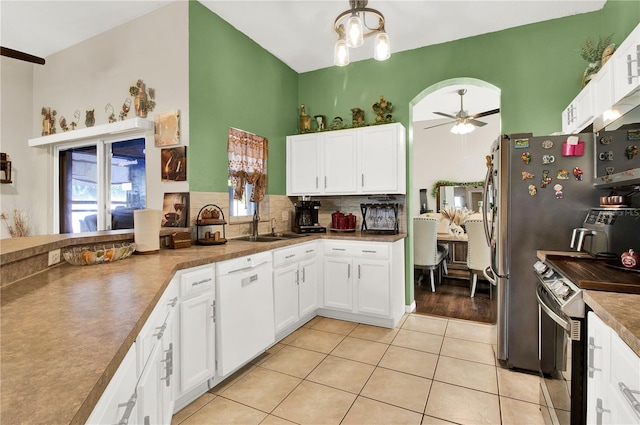 kitchen with a healthy amount of sunlight, ceiling fan with notable chandelier, white dishwasher, and light hardwood / wood-style floors