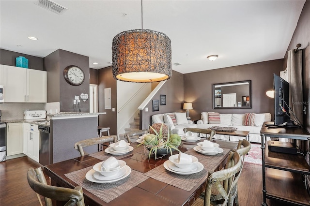 dining space with dark hardwood / wood-style flooring