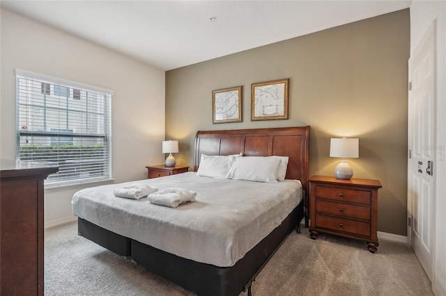 bedroom with light carpet and a closet