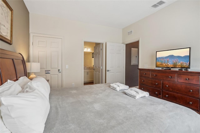 bedroom with carpet floors and ensuite bathroom