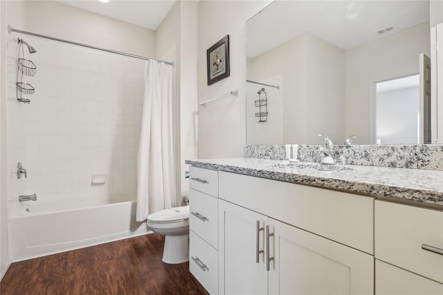 full bathroom featuring toilet, shower / bath combination with curtain, vanity, and wood-type flooring