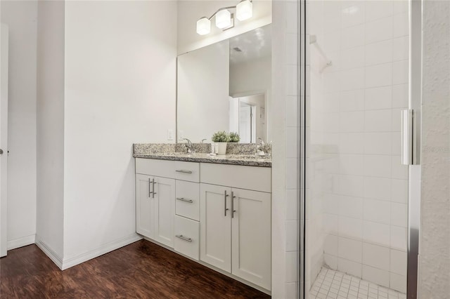 bathroom featuring vanity, hardwood / wood-style floors, and walk in shower