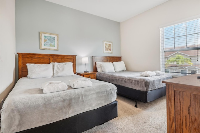 bedroom featuring light colored carpet