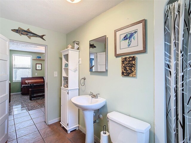 bathroom featuring tile patterned flooring and toilet