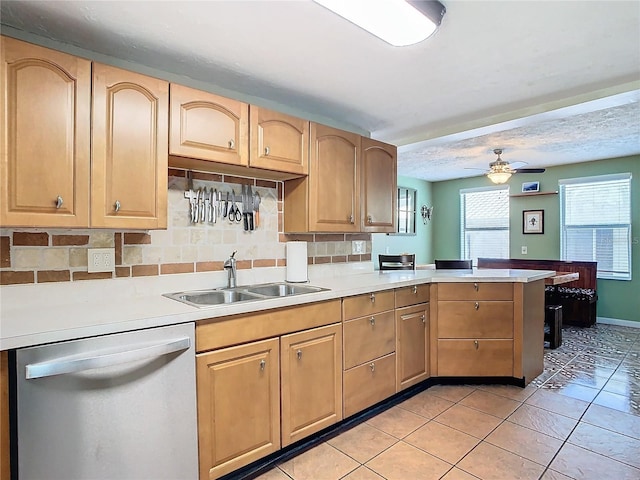 kitchen with ceiling fan, light tile patterned flooring, sink, kitchen peninsula, and stainless steel dishwasher