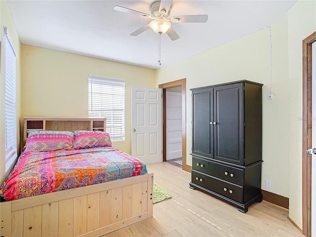 bedroom with light wood-type flooring and ceiling fan