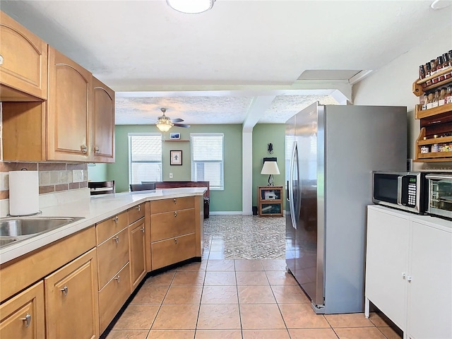 kitchen with backsplash, light brown cabinets, light tile patterned floors, stainless steel appliances, and ceiling fan