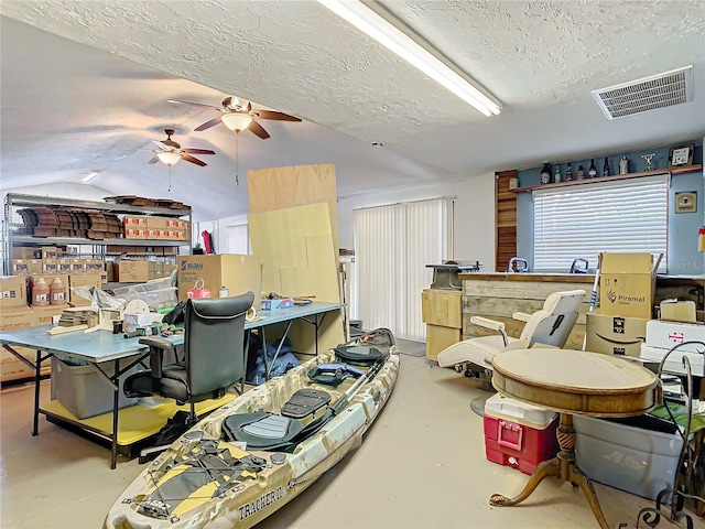 misc room featuring a textured ceiling and ceiling fan