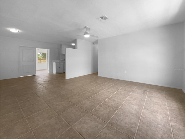 unfurnished room with tile patterned floors and ceiling fan