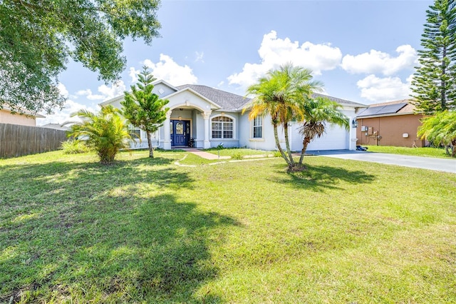 ranch-style house featuring a front yard and a garage