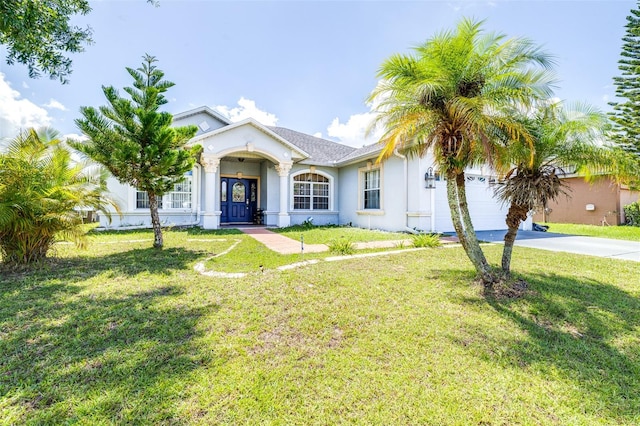 view of front of property with a front yard and a garage