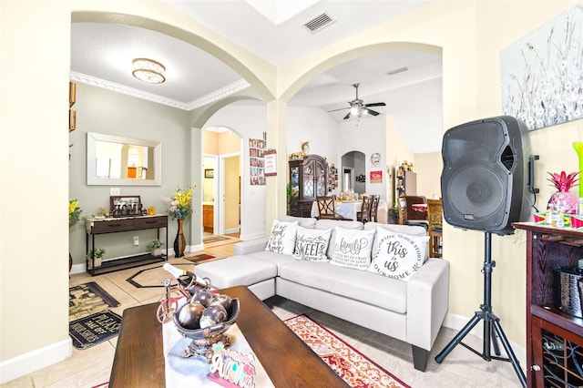 living room featuring light tile patterned floors, crown molding, and ceiling fan