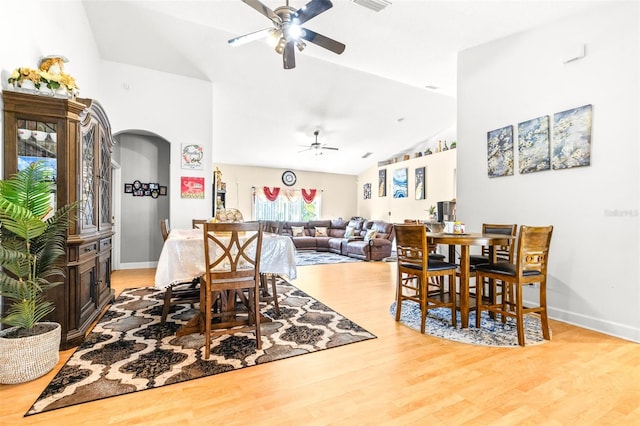 dining room featuring ceiling fan, vaulted ceiling, and light hardwood / wood-style flooring